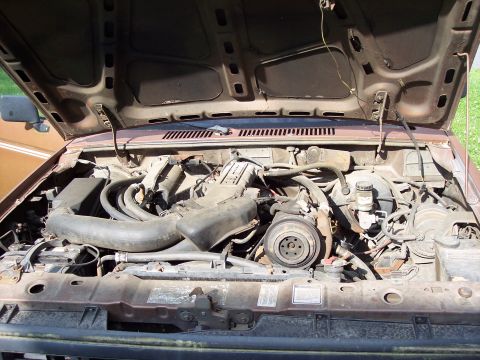 1986 Ford Bronco II - Engine bay of a 1986 Ford Bronco II, showing the V6 engine and associated components.