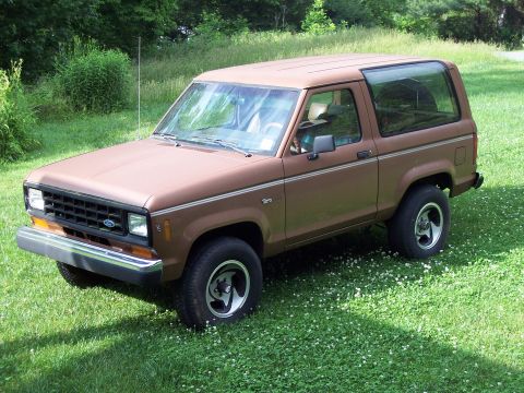 1986 Ford Bronco II - This 1980s Ford Bronco II is shown from a 3/4 front angle, parked on a grassy lawn.