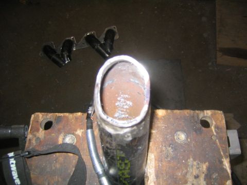 1978 Ford Bronco - Custom exhaust manifold and pipe section held in a vise, ready for fabrication.