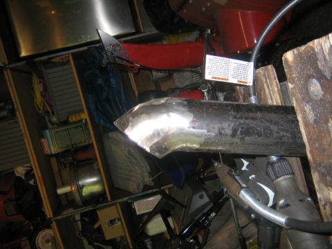 1978 Ford Bronco - A close-up view of a metal pipe being welded, surrounded by various items in a workshop.