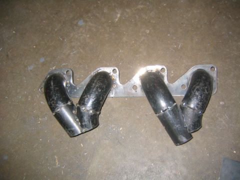 1978 Ford Bronco - Custom turbo headers are shown on a concrete surface.