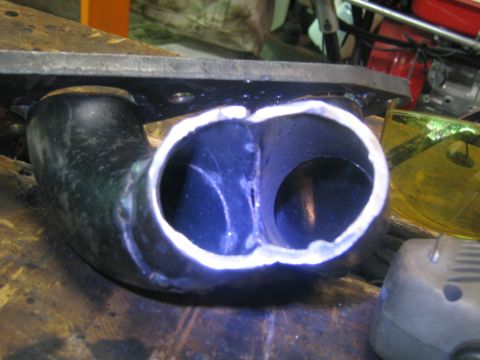 1978 Ford Bronco - A close-up view of a custom-welded exhaust header, showing the dual pipe configuration.