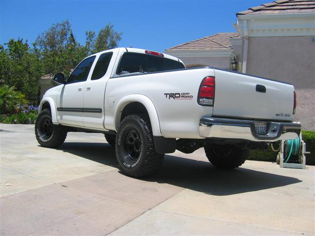 White lifted Toyota Tundra pickup with TRD Off Road decal, 3/4 rear view