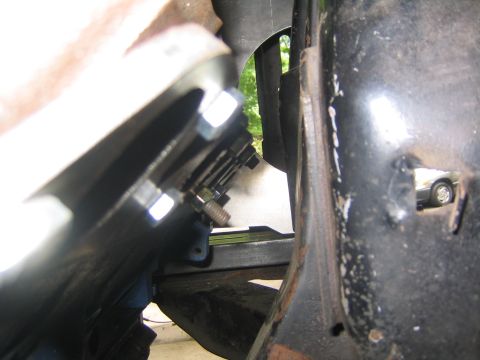 1978 Ford Bronco - Bolted metal brackets and engine components are visible in a close-up view of a vehicle's engine bay.