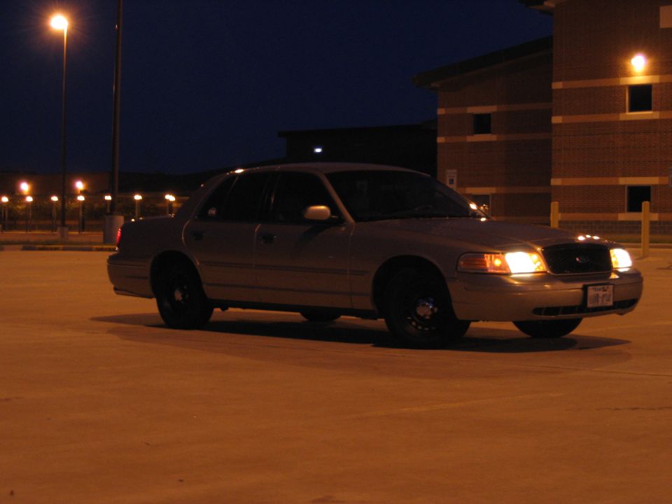 Silver sedan parked at night, 3/4 front view