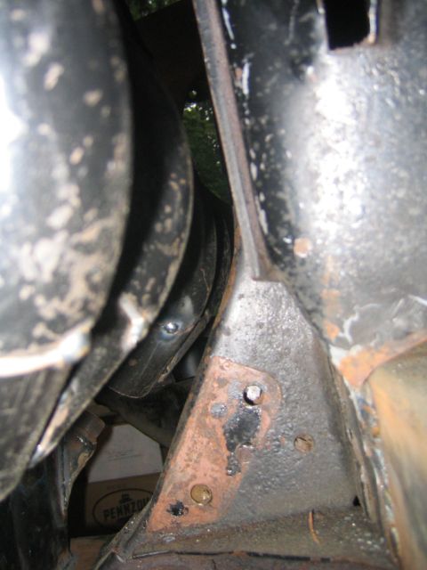 1978 Ford Bronco - Detail of vehicle frame and exhaust pipe, showing rust and wear.