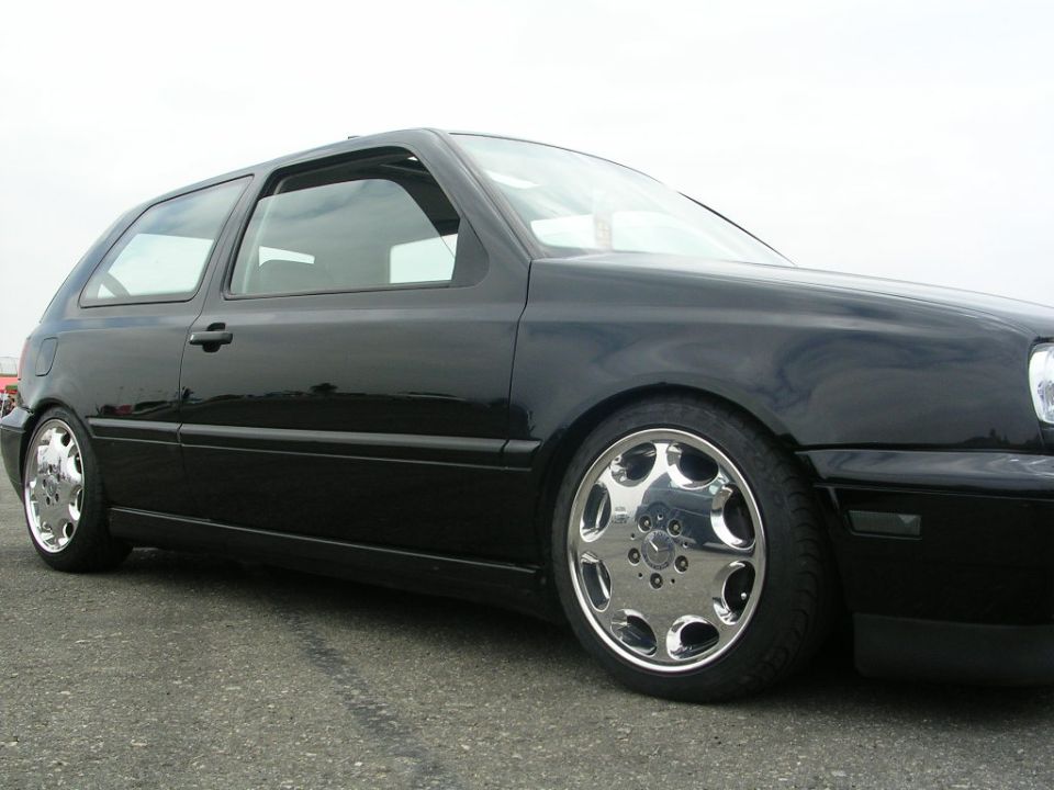 Black Volkswagen Golf Mk3, side profile, lowered with chrome wheels