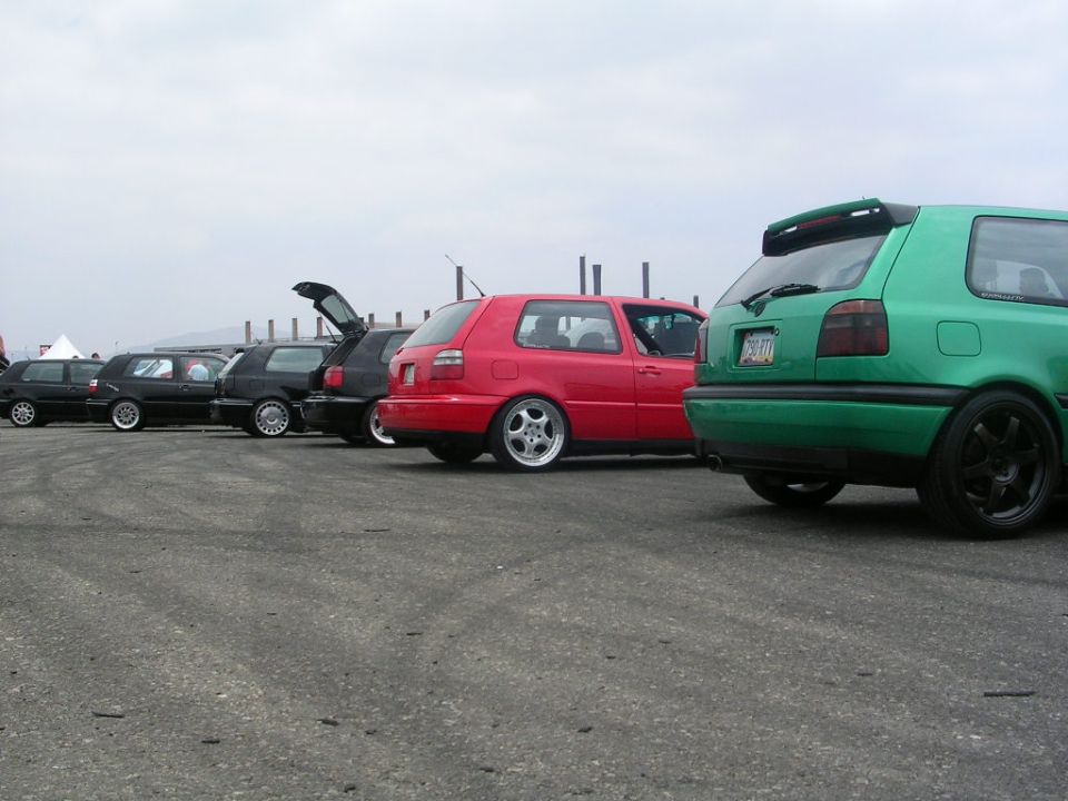 Green Volkswagen Golf Mk3 hatchback with a rear spoiler and black wheels