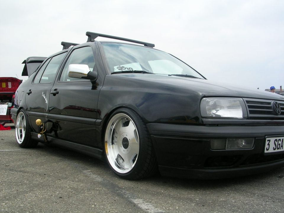 Black Volkswagen Golf Mk3 with chrome wheels and roof rack