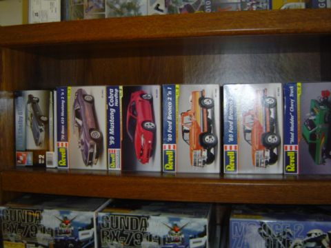 1979 Ford Bronco - Several model car boxes are displayed on a wooden shelf, showing various vehicle types and truck kits.