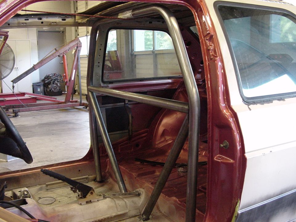 Interior of a car with a roll cage and stripped-down interior