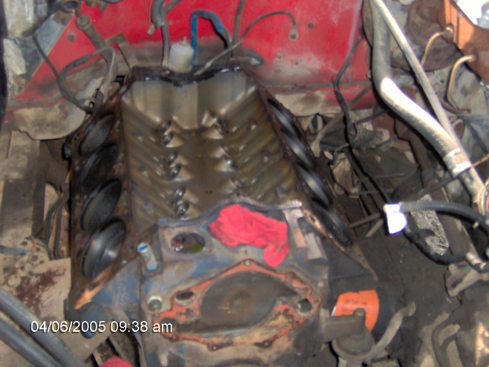 Engine block with valves visible, red rag stuffed into a cylinder opening