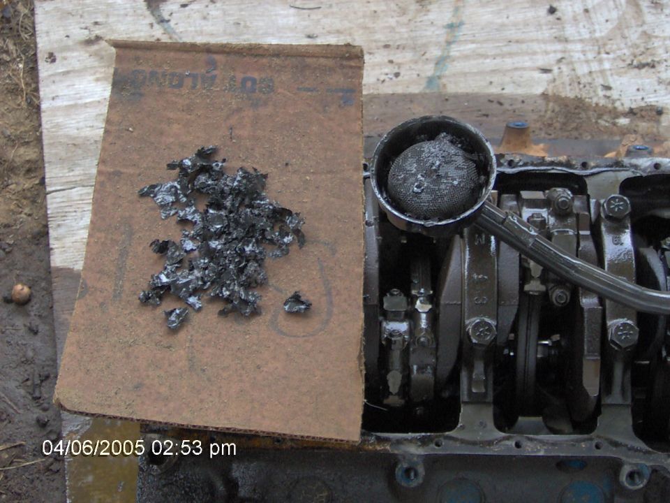 Engine block with debris and oil filter. Date stamp 04/06/2005