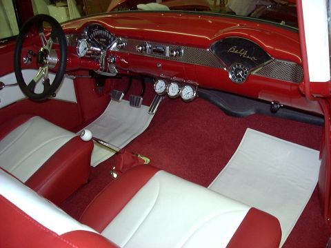 1994 Ford Bronco - The dashboard and seats of a classic Chevrolet are shown, a prominent 'Bel Air' emblem.