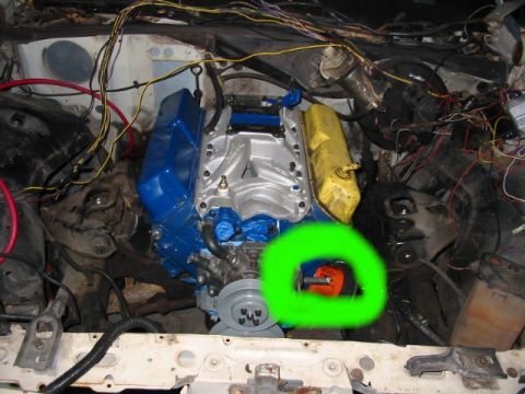 2000 Ford Crown Victoria - The engine bay shows a distributor circled in green, with various wires and engine components visible.