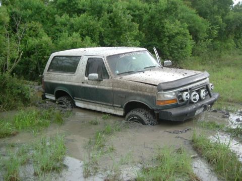 1996 Ford Bronco - This 1996 Ford Bronco is deeply stuck in mud, with only its upper body visible above the mire.