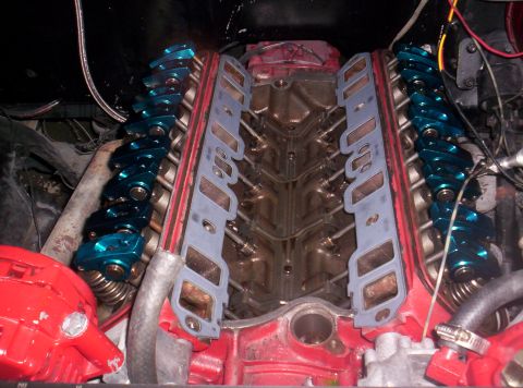 1989 Ford Bronco II - Engine components including blue roller rockers and intake gaskets are visible in this close-up view.