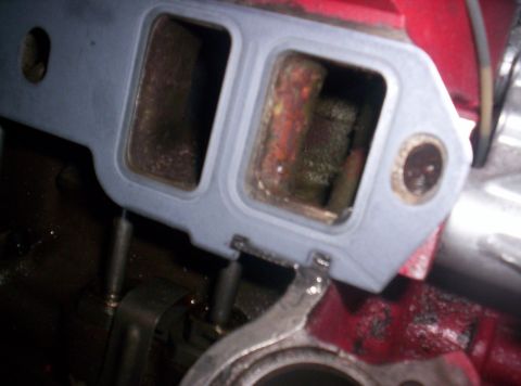 1989 Ford Bronco II - Close-up of an intake manifold gasket during engine work.