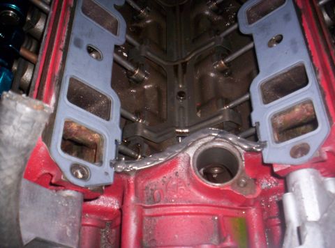 1989 Ford Bronco II - Close-up view of engine block with intake manifold gaskets being prepared for installation.