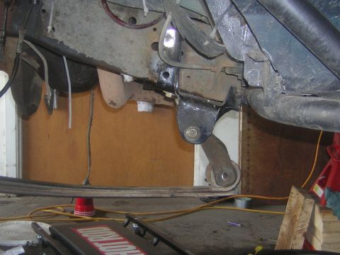 1995 Ford Bronco - Underside view of a vehicle's suspension system, showing leaf springs and mounting hardware.