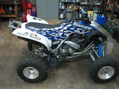 1991 Ford Bronco - A quad bike with custom graphics is parked in a garage.