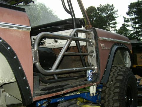 1995 Ford Bronco - Custom roll cage fitted inside a classic Ford Bronco, modifying the interior structure.