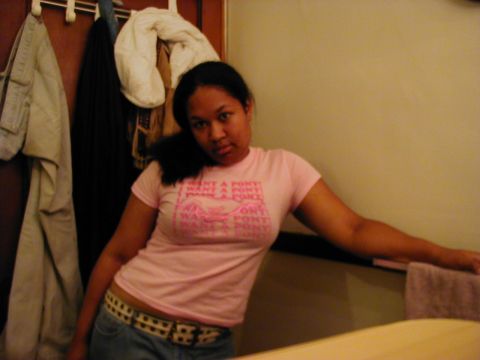 1997 Ford Taurus - A woman poses for a photo while wearing a pink t-shirt with text and jeans.