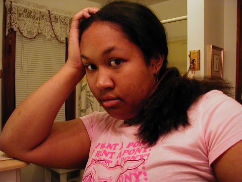 1997 Ford Taurus - A woman rests her head in her hand while wearing a pink t-shirt with graphics.