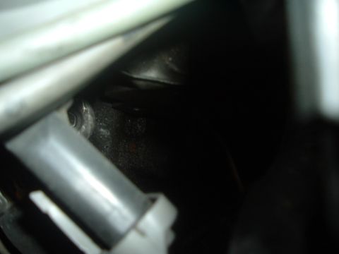 1993 Ford Taurus - A close-up view of an engine component, showing some wear and tear.