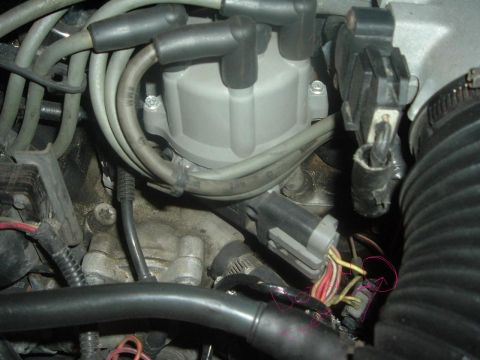 1993 Ford Taurus - This image shows a close-up view of engine components, specifically the distributor cap and associated wiring.