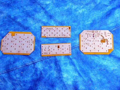 1978 Ford Mustang II - Four electronic circuit boards are laid out on a blue textured surface. The registry claims they are from a 1978 Ford Mustang II, but this…