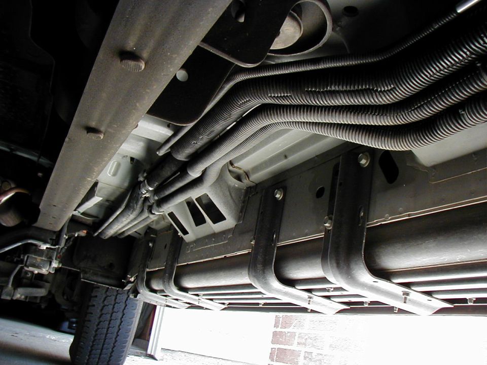 There's about 4 mounting clamps holding up the 4 lines to the bottom of the truck body which will have to be dropped in order to remove the wire loom covering and insulation.