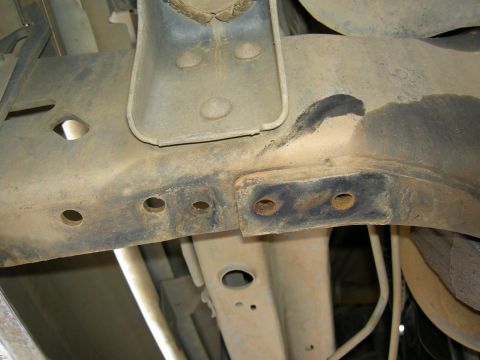 1988 Ford Bronco - Close-up of the undercarriage, showing the frame and suspension system of a vehicle.