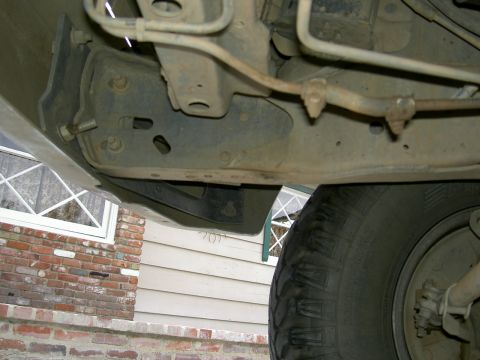 1988 Ford Bronco - Close-up view of a vehicle's undercarriage, focusing on a tow hook mounting bracket.