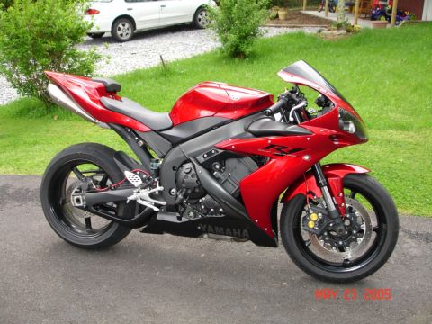 2004 Yamaha R1 - A red Yamaha R1 sportbike is parked on a driveway with a white car and green grass in the background.