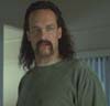 1986 Pontiac Fiero - A man with a mustache and long hair is seen in this scene.