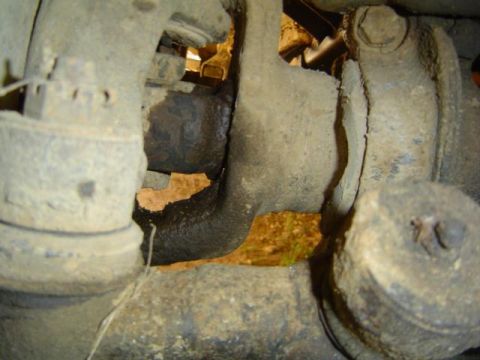 1979 Ford Bronco - Undercarriage view of aged suspension components, the Supermotors.net watermark.