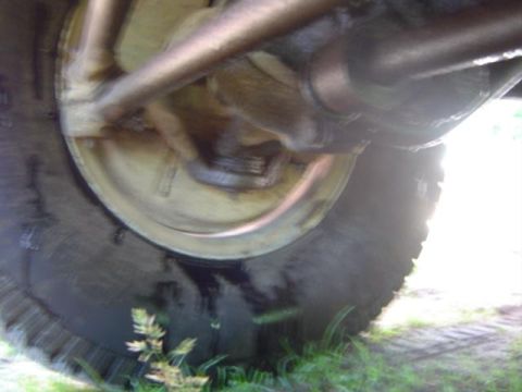 1979 Ford Bronco - Underside view of a vehicle's wheel and suspension system, showing mechanical parts.