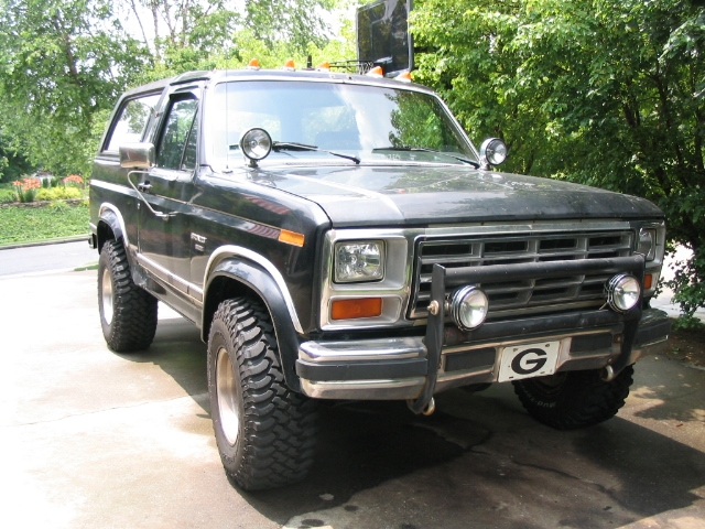 Black Ford Bronco, 3/4 front view, with off-road tires and aftermarket bumper