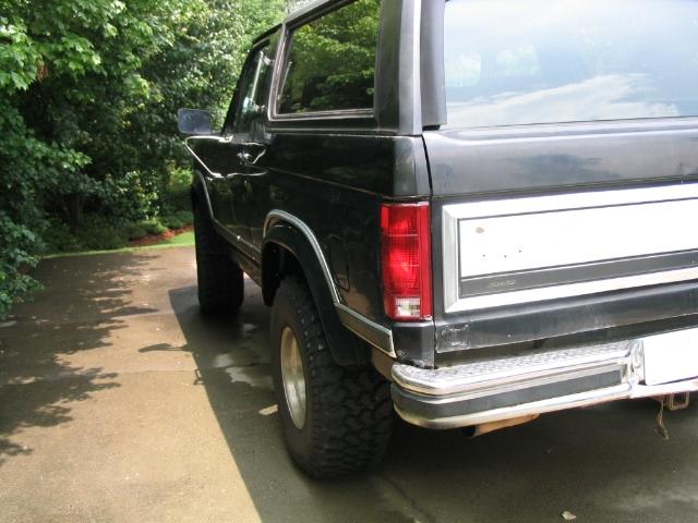 Black Ford Bronco, rear quarter view. Lifted with off-road tires