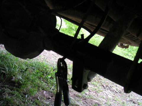 1994 Ford Bronco - Jumper cables are connected to the differential of a vehicle, suggesting a repair or charging situation.