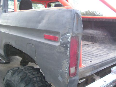 1979 Ford Bronco - Rear view of a 1979 Ford Bronco showing extensive body damage to the quarter panel and tailgate.
