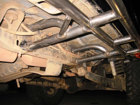 1988 Ford Bronco - Custom metal tubing is welded to the undercarriage of this off-road vehicle for protection.