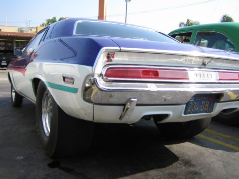 1985 Ford Mustang - This 1970 Dodge Challenger, seen from the rear, features drag tires and a distinctive blue, white, and red paint scheme.