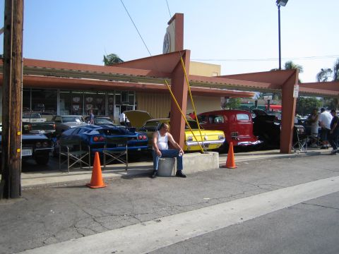 1985 Ford Mustang - A car show features a variety of classic vehicles, including a yellow 1965 Ford Mustang and a blue Lamborghini.