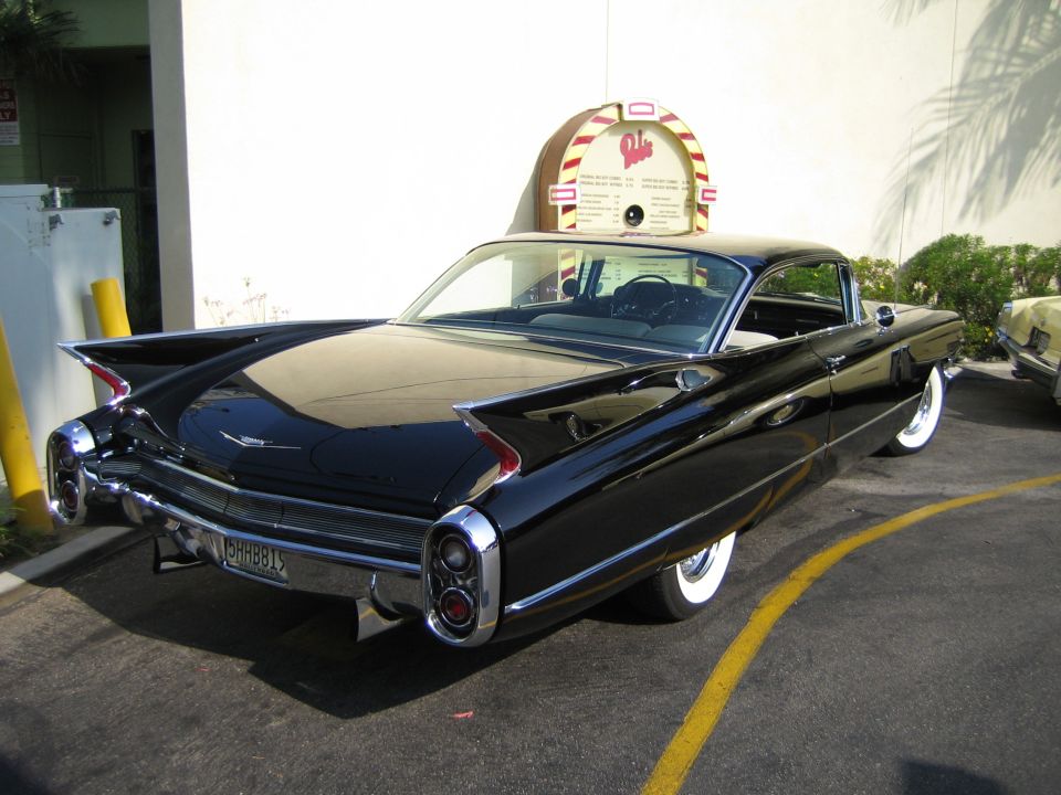 Black 1959 Cadillac Eldorado rear view with fins and dual taillights. License plate is JGH-881
