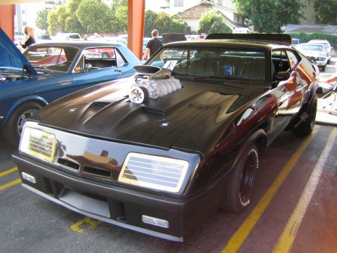 1985 Ford Mustang - This heavily modified car, likely a 1979 Ford Falcon, is parked next to a blue vehicle.