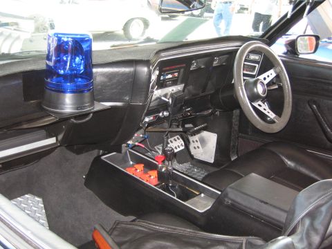 1985 Ford Mustang - Interior view of a 1985 Ford Mustang, a blue emergency light and custom modifications.