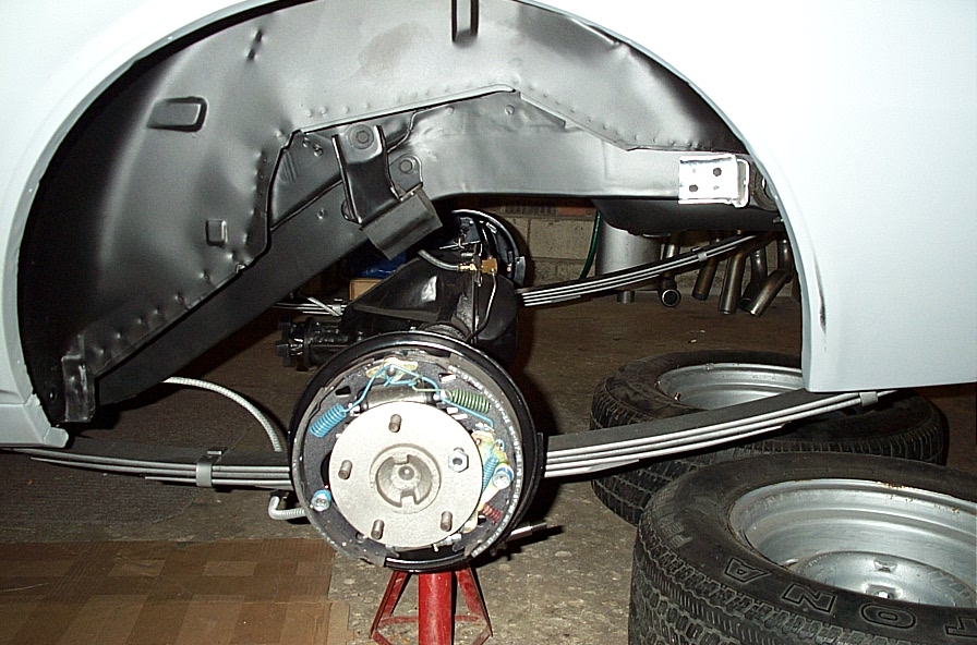 1968 Chevrolet Camaro rear axle assembly with leaf springs and brake drum, undergoing restoration
