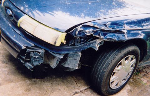 1993 Ford Taurus - Front end damage on a 1993 Ford Taurus, with the headlight area taped off.